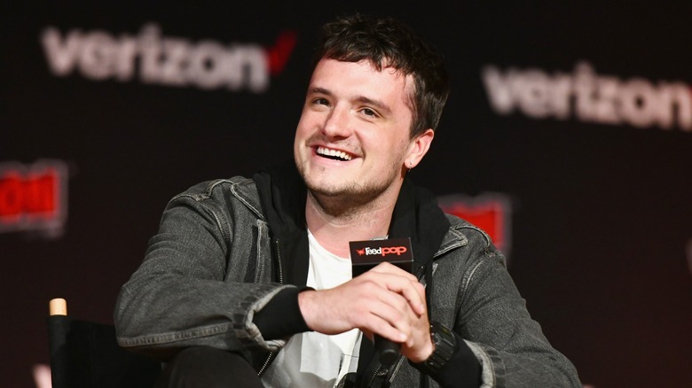 Josh Hutcherson holding a microphone