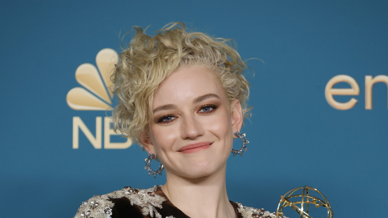 Julia Garner posing at the Emmy awards