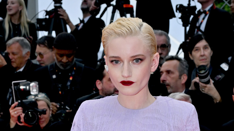 Julia Garner posing on the Eddington red carpet