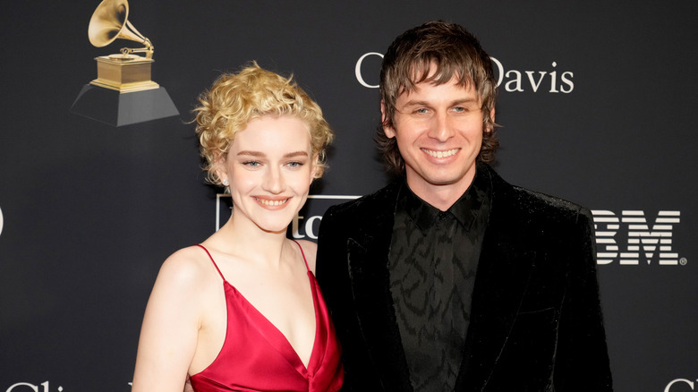 Julia Garner and Mark Foster posing together at the Grammy awards
