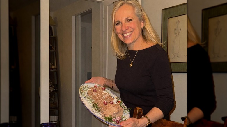 Emma Walton Hamilton smiling while holding a plate of food in 2025
