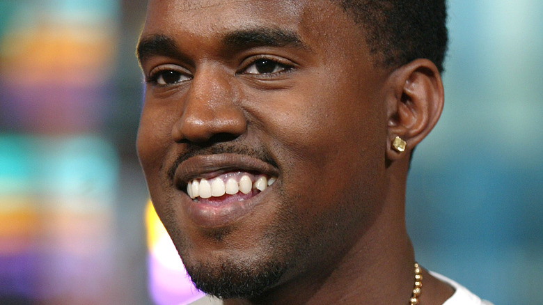 A younger Kanye West smiling 