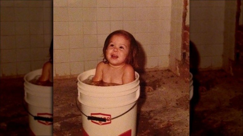 Kat Von D as a young girl in a bucket