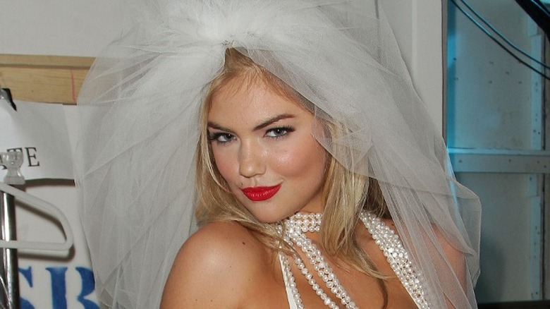 Kate Upton posing in lingerie and wedding veil