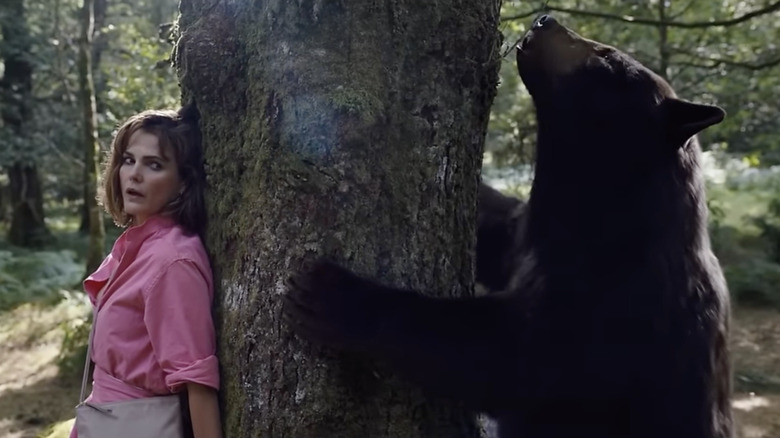 Keri Russell fleeing a bear in a scene from "Cocaine Bear"
