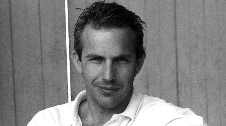 Young Kevin Costner looking directly into camera