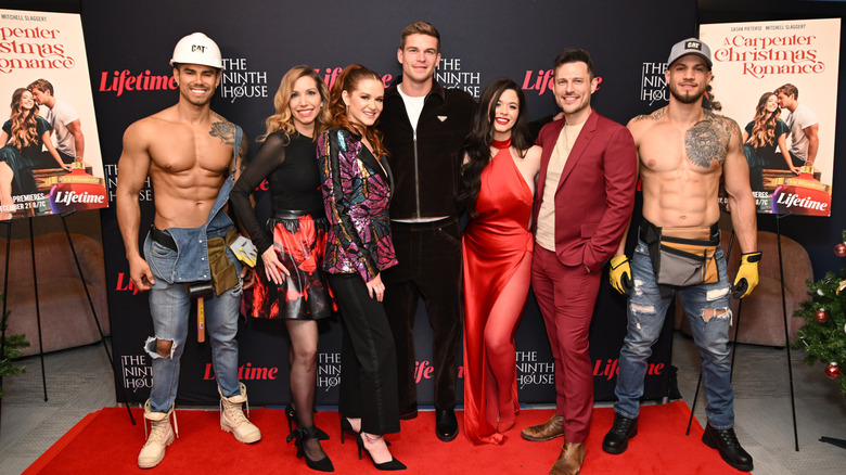 Mitchell Slaggert in black track suit with the cast of "A Carpenter Christmas Romance"