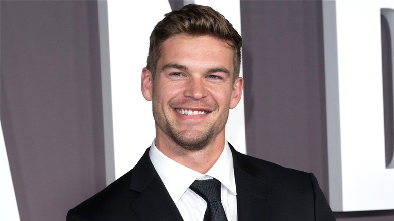 Close up of Mitchell Slaggert smiling in a black suit and tie at the 2024 