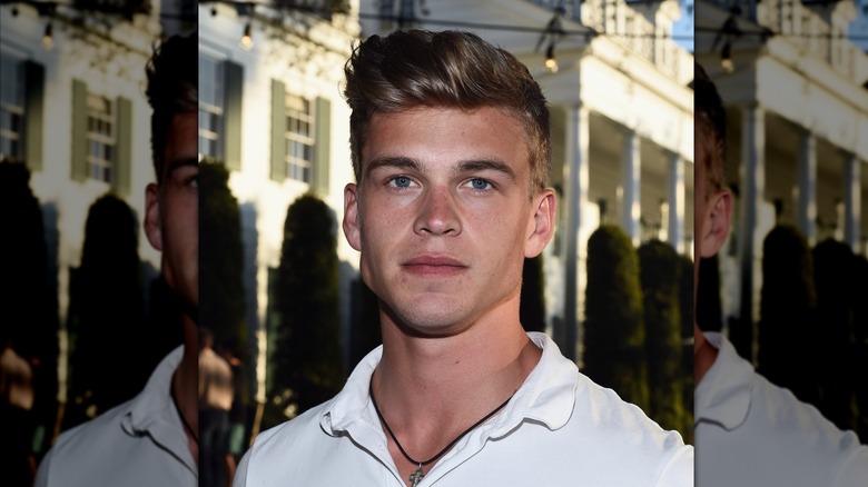 Mitchell Slaggert in white polo shirt not smiling