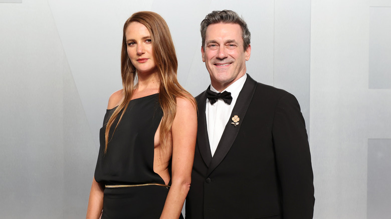 Jon Hamm wearing a tuxedo while posing with wife Anna Osceola