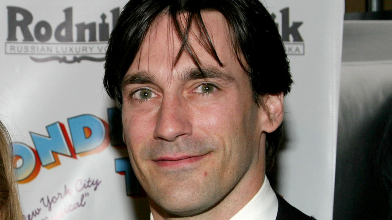 Smiling Jon Hamm posing for a photo in the early 2000s