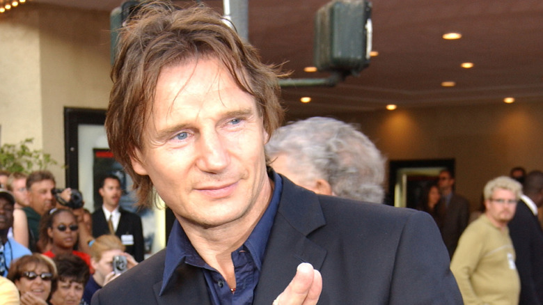 Liam Neeson waving to fans