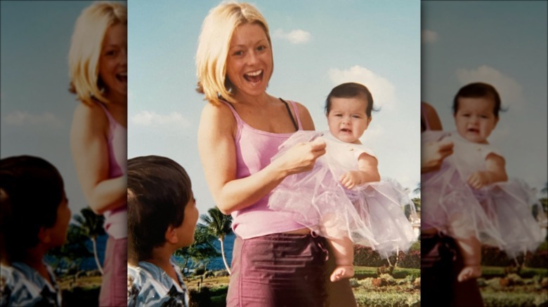 Kelly Ripa holding a young Lola Consuelos