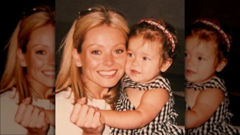 Kelly Ripa holding a young Lola Consuelos