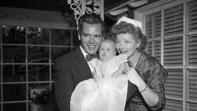 Desi Arnaz and Lucille Ball holding their daughter, Lucie Arnaz