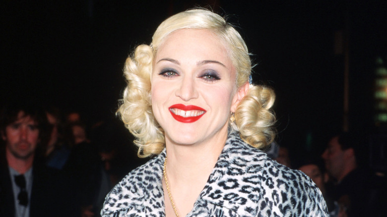 Madonna smiling in a leopard print coat