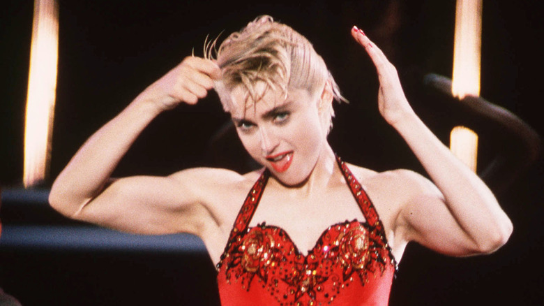 Madonna performing in a red bustier