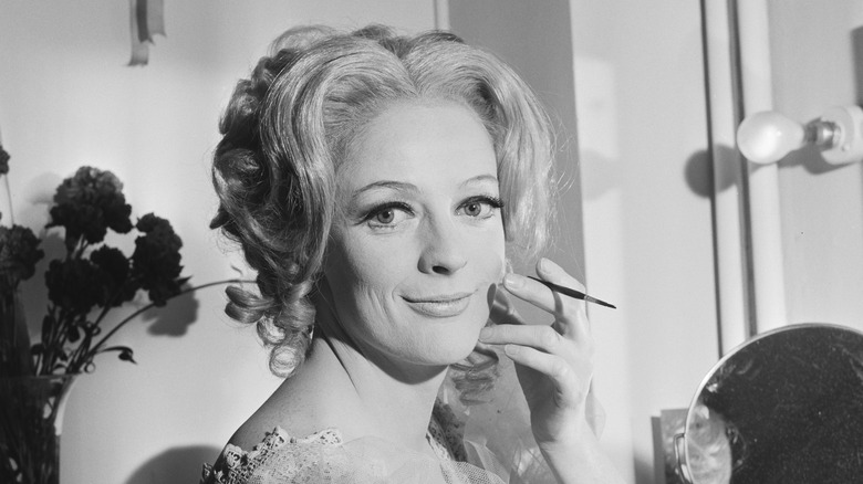 Maggie Smith applying makeup backstage