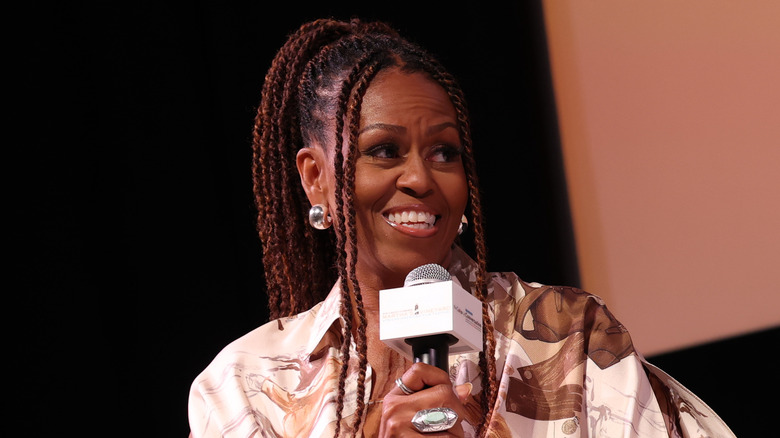 Michelle Obama speaking into microphone