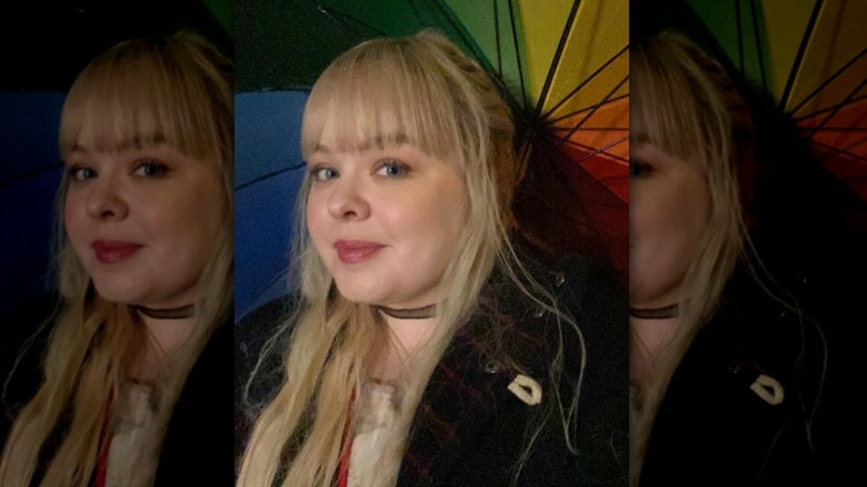 Nicola Coughlan smiling under Pride umbrella