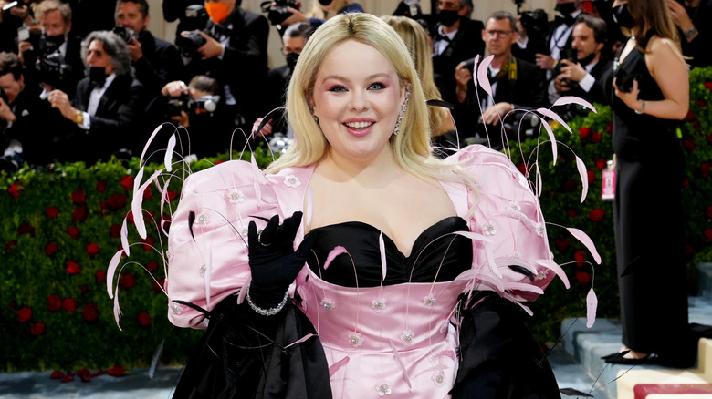 Nicola Coughlan eaving on step-and-repeat