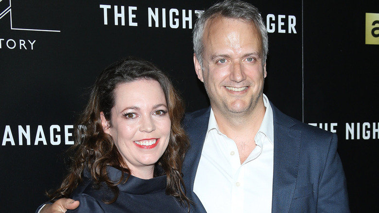 Actor Olivia Colman smiles next to her husband Ed Sinclair at an event in 2016