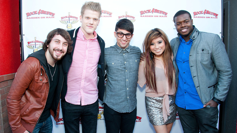 Pentatonix posing on step-and-repeat