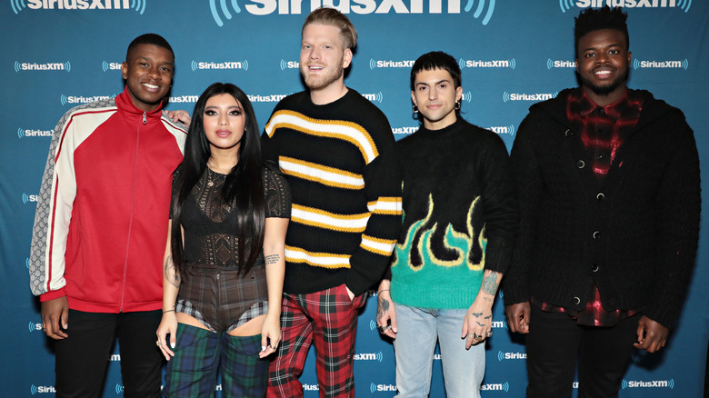 Pentatonix posing on step-and-repeat