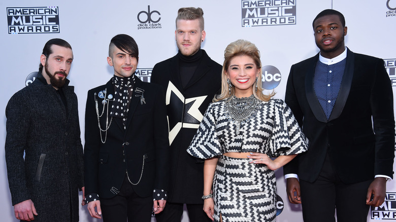 Pentatonix posing on step-and-repeat