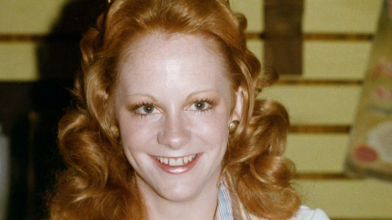Teenage Reba McEntire grinning