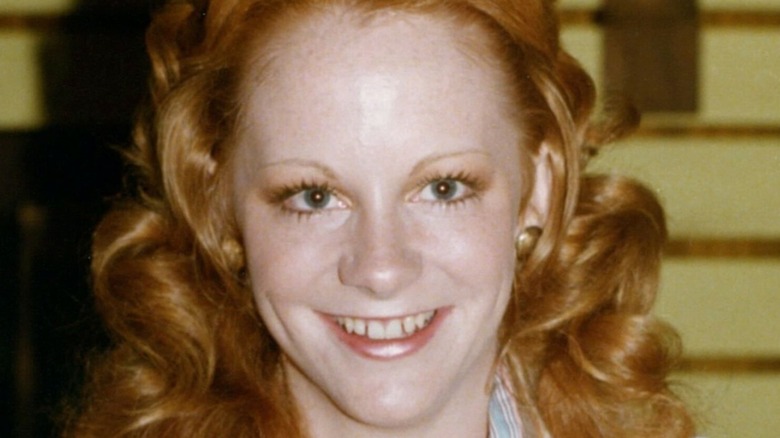 Teenage Reba McEntire grinning