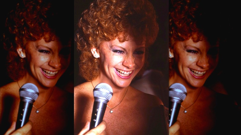 Reba McEntire laughing into microphone