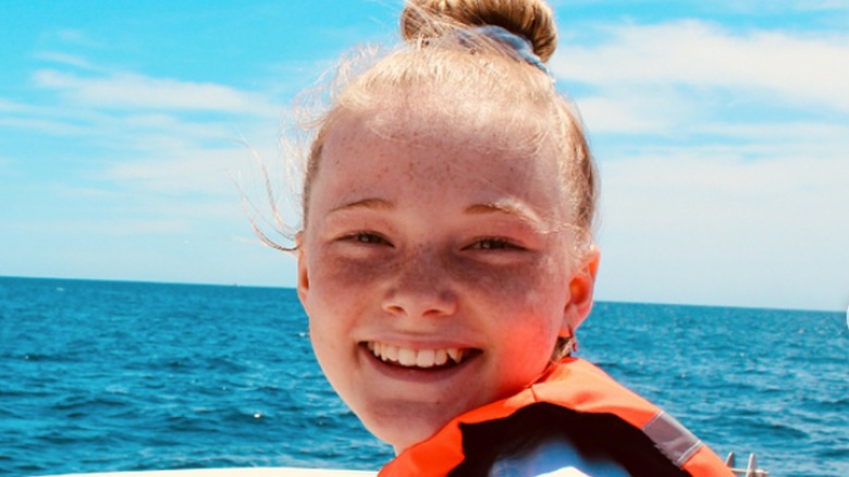 Rylee Arnold smiling on boat