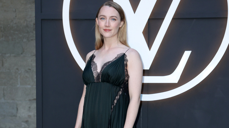 Saoirse Ronan smiling at the Louis Vuitton Cruise 2026 photocall in 2025