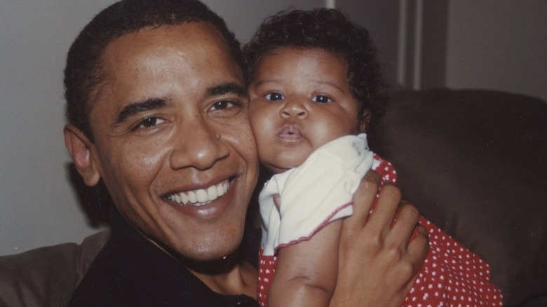 Barack Obama holding baby Sasha Obama