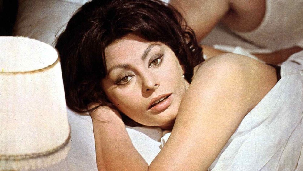 Sophia Loren laying in a bed, looking up