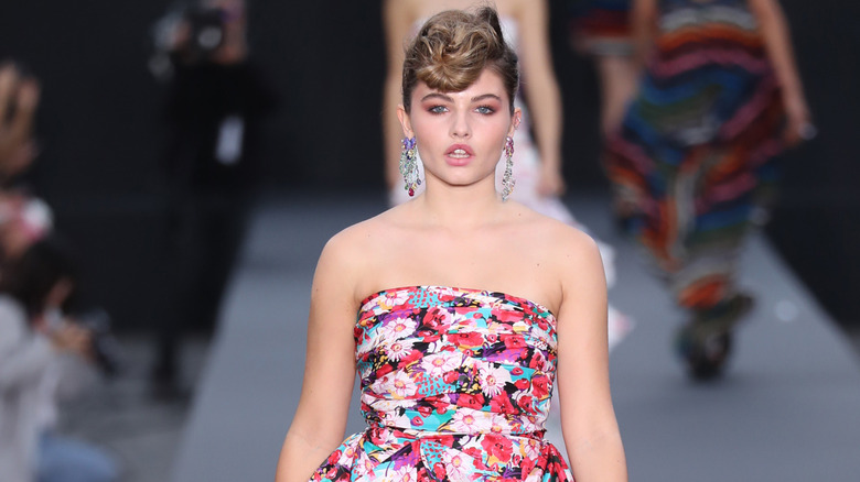 Thylane Blondeau wearing a strapless dress on the runway in 2017