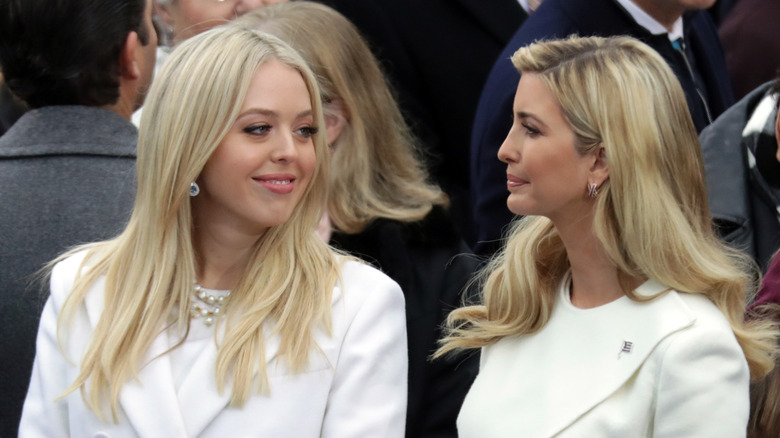 Tiffany and Ivanka Trump stand together in white outfits