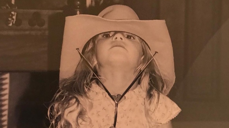 Audrey McGraw wears a cowboy hat as a toddler looking up