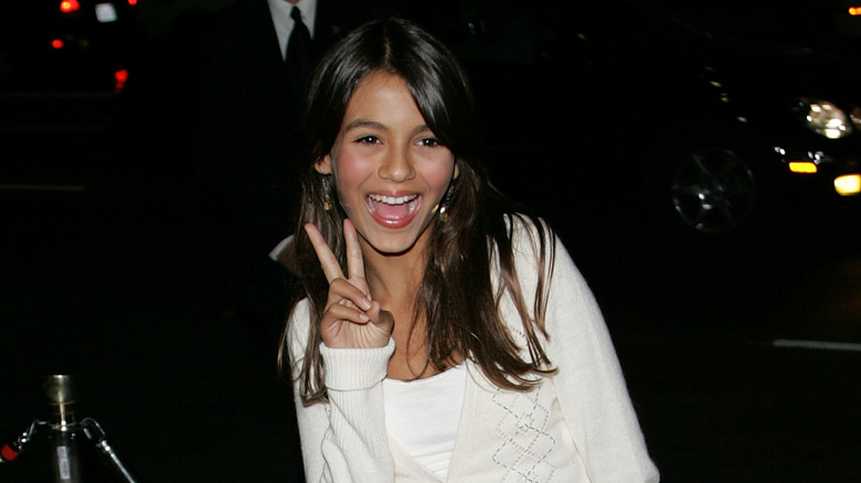 Victoria Justice making a peace sign