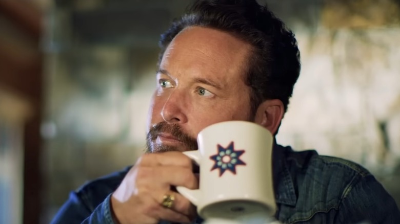 Cole Hauser drinking from a Free Rein coffee mug
