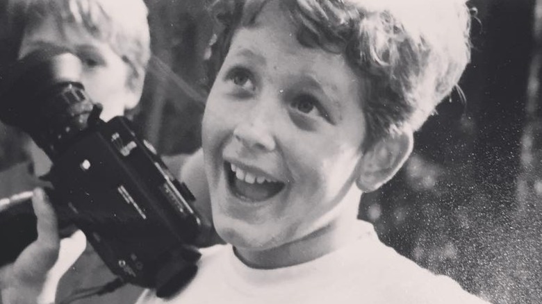 Cole Hauser as a child holding a camcorder