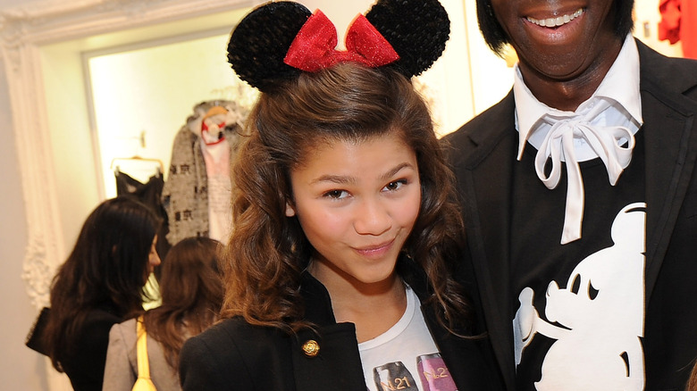 Zendaya as a child smiling in Mickey mouse ears.