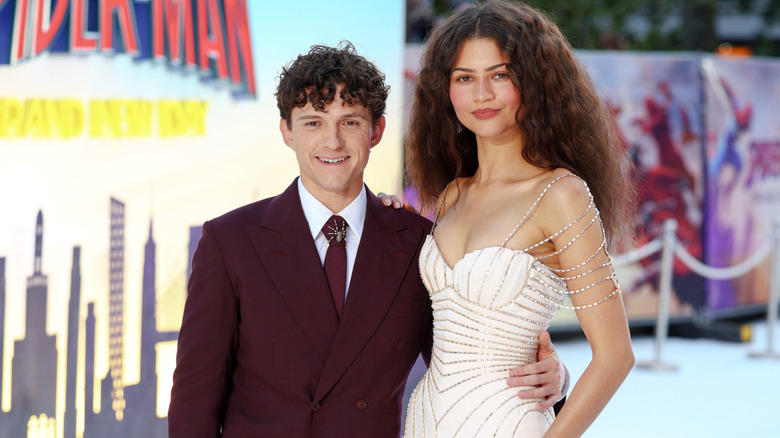 Zendaya and Tom Holland posing together on the red carpet.