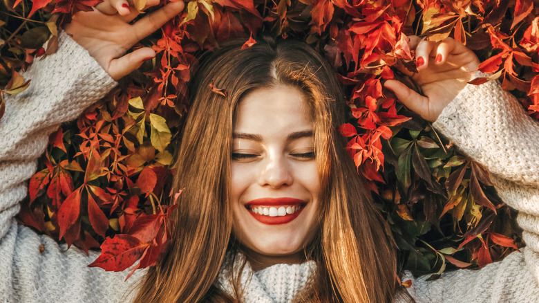 A woman laying on leaves 