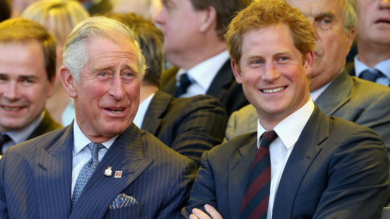 King Charles and Prince Harry smiling