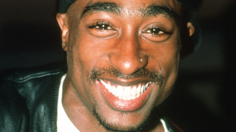 Tupac smiles at the camera