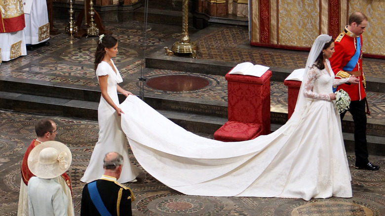 Pippa Middleton holding Kate Middleton's wedding dress train