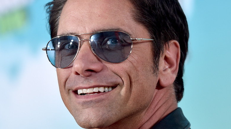 John Stamos smiling in sunglasses