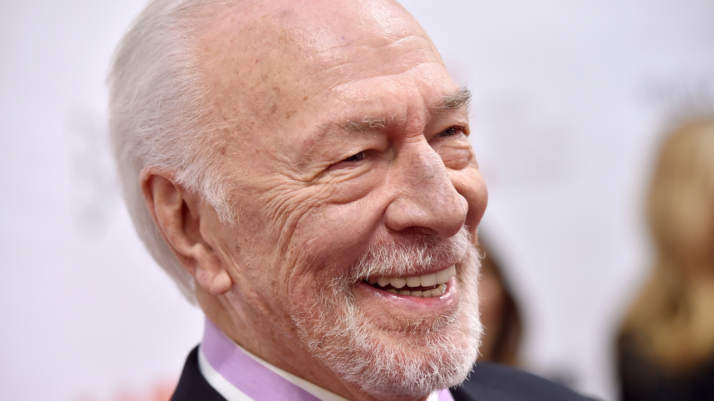 Christopher Plummer smiling with white backdrop